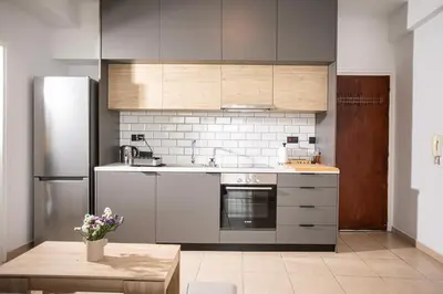 a kitchen with stainless steel appliances and a table at Sky-view Hideaway in Nicosia