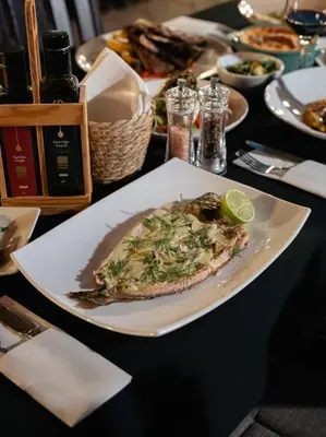 a plate with a slice of pizza on a table at Pine View Boutique Hotel Adults Only in Saittas