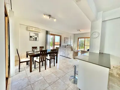 a kitchen and dining room with a table and chairs at Lovely Pool Villa in Pyla in Pyla