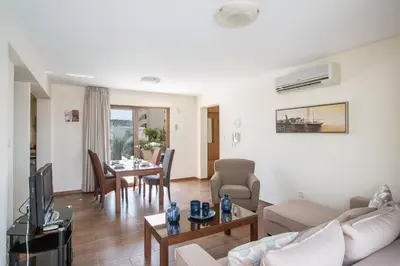 a living room with a couch and a table at Ayia Napa Holiday Apartment Na101 in Ayia Napa