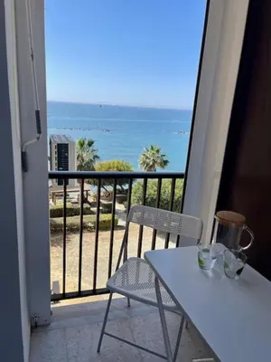 a balcony with a table and a view of the ocean at Seaside Studio Zygi in Zygi