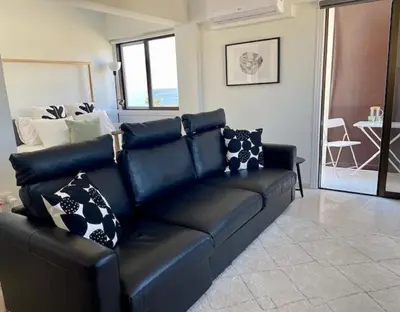a black leather couch in a living room at Seaside Studio Zygi in Zygi