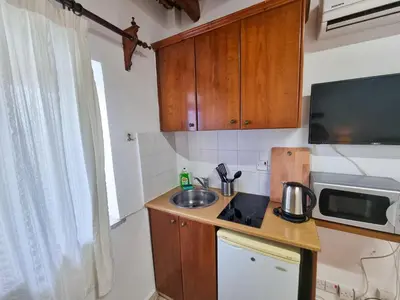 a small kitchen with a sink and a microwave at Athena's Pool Oasis in Skarinou