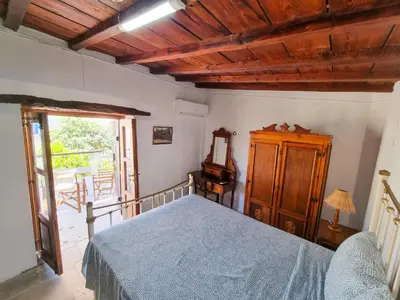 a bedroom with a bed and a wooden ceiling at Athena's Pool Oasis in Skarinou