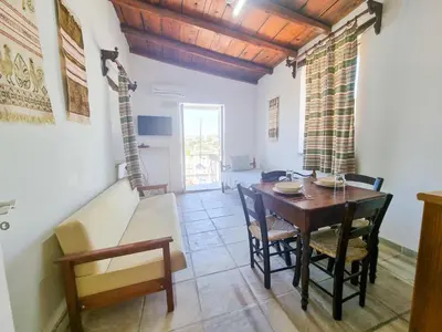 a dining room with a wooden table and chairs at Athena's Pool Oasis in Skarinou
