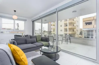 a living room with a couch and a table at Mirage 2-BR Apartment in Larnaca in Larnaka