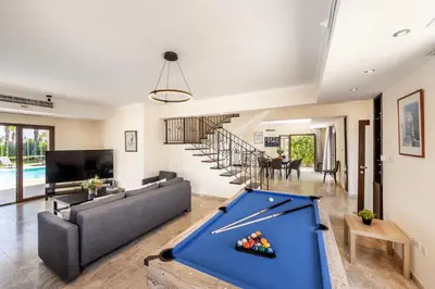 a living room with a pool table in the middle at SunnyVillas: 4BR SeaFront Villa*Private Pool*BW44 in Protaras