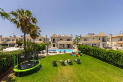 an aerial view of a yard with chairs and a trampoline at SunnyVillas: 4BR SeaFront Villa*Private Pool*BW44 in Protaras