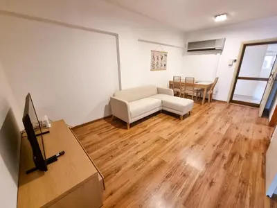 a living room with a couch and a table at CityCenter Apartment in Larnaka