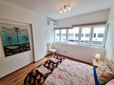 a bedroom with a large bed and a window at CityCenter Apartment in Larnaka