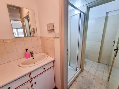 a bathroom with a sink and a shower at CityCenter Apartment in Larnaka