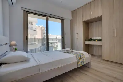 a bedroom with a large bed and a large window at Lemon Paradise City centre 200m from beach in Larnaka