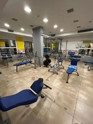 a gym with a bunch of blue chairs in a room at Antiparos 1 bedroom APT Kyklades in Paralimni