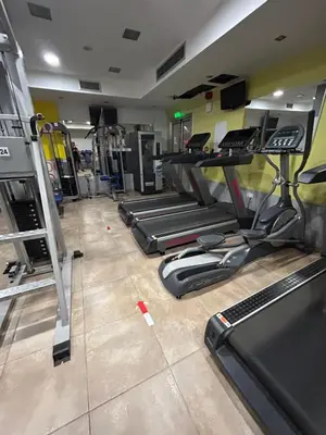 a gym with a row of treadles in a room at Paros 1 bedroom APT Kyklades in Paralimni