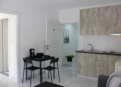 a kitchen with a table and chairs in a room at Amalia Residences in Nicosia