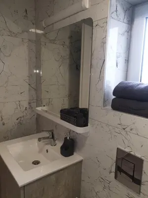 a bathroom with a sink and a mirror at Amalia Residences in Nicosia