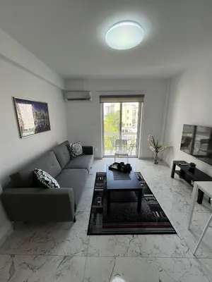 a living room with a couch and a table at Amalia Residences in Nicosia