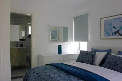 a bedroom with a bed with blue and white at Amalia Residences in Nicosia