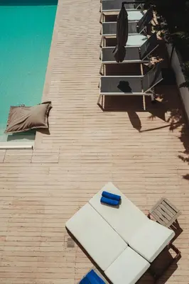 an overhead view of a deck with lounge chairs and a pool at Protaras Beachfront Villa Blue Waves in Protaras