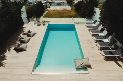 an overhead view of a swimming pool with lounge chairs at Protaras Beachfront Villa Blue Waves in Protaras