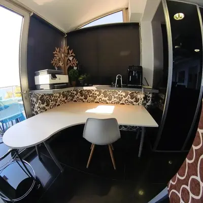 a kitchen with a white table and a chair at The View Beach Penthouse in Limassol