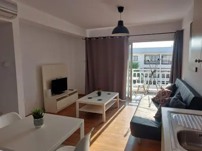 a living room with a couch and a table at Sunny Breeze in Ayia Napa