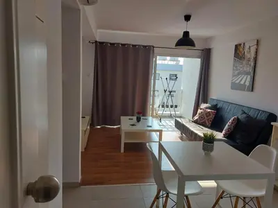 a living room with a couch and a table at Sunny Breeze in Ayia Napa