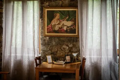 a painting of a woman playing a instrument on a table at Morfeas Kakopetria in Kakopetria