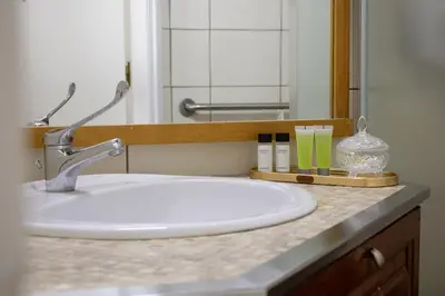 a bathroom counter with a sink and a mirror at Morfeas Kakopetria in Kakopetria