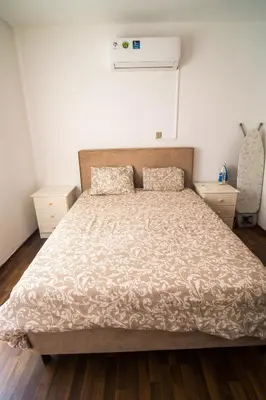 a bedroom with a bed with a comforter at Mezzarina apartment ayia napa in Ayia Napa