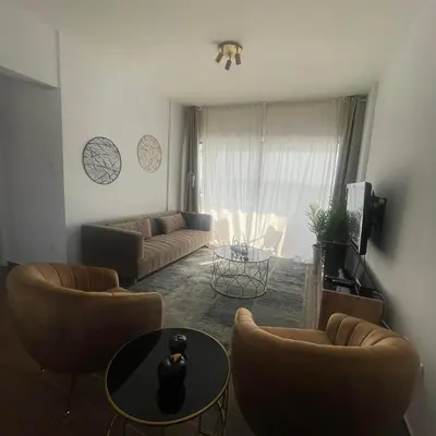 a living room with a couch and chairs and a table at Glamorous, Renovated 3-Bedroom Apt in Nicosia in Nicosia