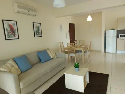 a living room with a couch and a table at Pyla Palms Resorts A2 102 in Pyla