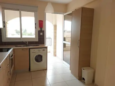 a kitchen with a washer and a sink and a washing machine at Pyla Palms Resorts A2 102 in Pyla
