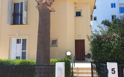 a column in front of a building with a statue at VILLA MARINA BY FIG TREE BAY in Protaras