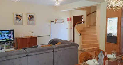 a living room with a couch and a tv at VILLA MARINA BY FIG TREE BAY in Protaras