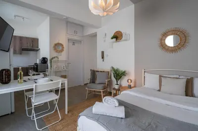 a bedroom with a bed and a desk and a computer at Orchid's Cozy Studio & Balcony in Larnaca in Larnaka