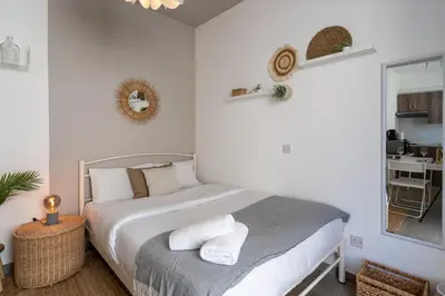 a bedroom with a bed with towels on it at Orchid's Cozy Studio & Balcony in Larnaca in Larnaka