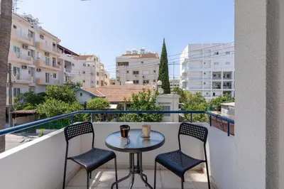 a table and chairs on a balcony with a view at A Blissful 1-Bedroom Voyage in Larnaca in Larnaka