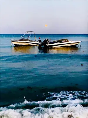 two boats sitting on the water in the ocean at LINA 25 in Larnaka