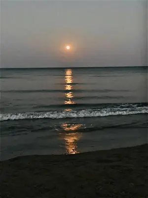 a sunset on a beach with the ocean at LINA 25 in Larnaka