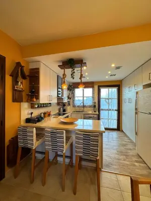 a kitchen with a table and some chairs in it at Sotira Agia Napa Luxury House in Ayia Napa
