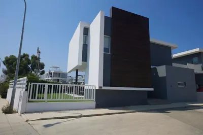 a building with a white fence in front of it at Protaras Olivine Villa Ol01 in Paralimni