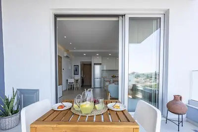 a dining room with a table with drinks on it at Rodoni Residence in Strovolos