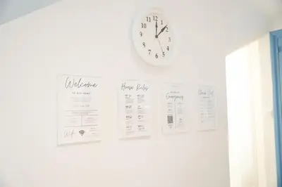 a clock hanging on a wall with some receipts at Ocean Blue House 17 in Meneou