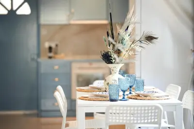 a white table with a vase on top of it at Ocean Blue House 17 in Meneou