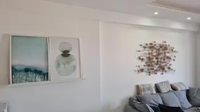 a living room with a couch and pictures on the wall at STAY Kallucci's maison de la mer in Larnaka