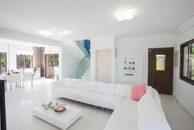 a white living room with a white couch and a table at Demetra Villa in Ayia Napa