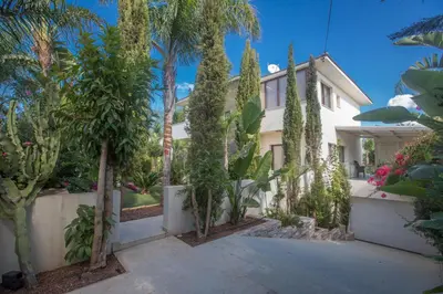 a house with trees and plants in front of it at Demetra Villa in Ayia Napa