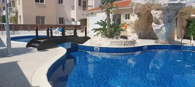 a swimming pool with a slide in a resort at Pyla Palms A2 107 in Pyla