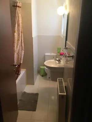 a small bathroom with a toilet and a sink at Alex Residence in Larnaka